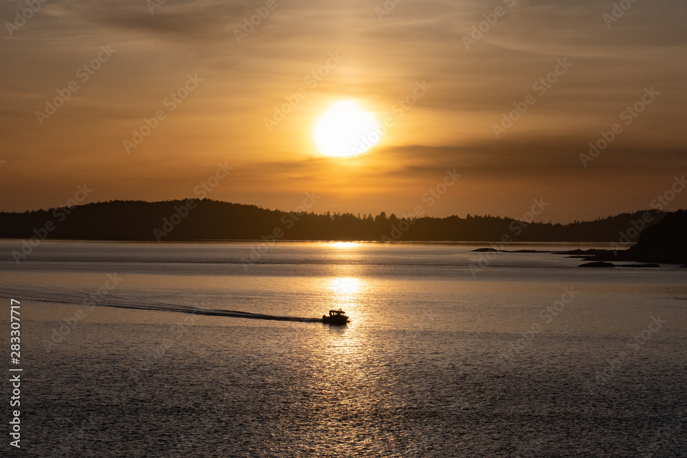 motor boat caught in the sun at sunset Vancouver Island