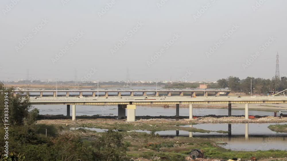automobile city traffic on the Signature cable-stayed bridge across the Yamuna River in Delhi against the background of the city automobile city traffic on the Signature cable-stayed bridge across the Yamuna River in Delhi against the background of the city