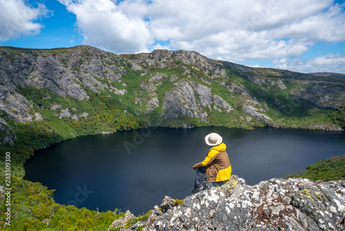 Traveller man explore landscape of Marions lookout trail in Cradle Mountain National Park in Tasmania, Australia. Summer activity and people adventure. photo