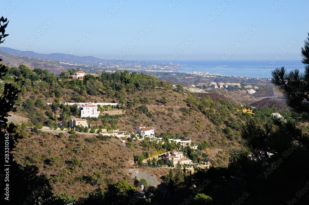 Elevated view across the mountains towards the Mediterranean sea, El Madronal, Andalusia, Spain.