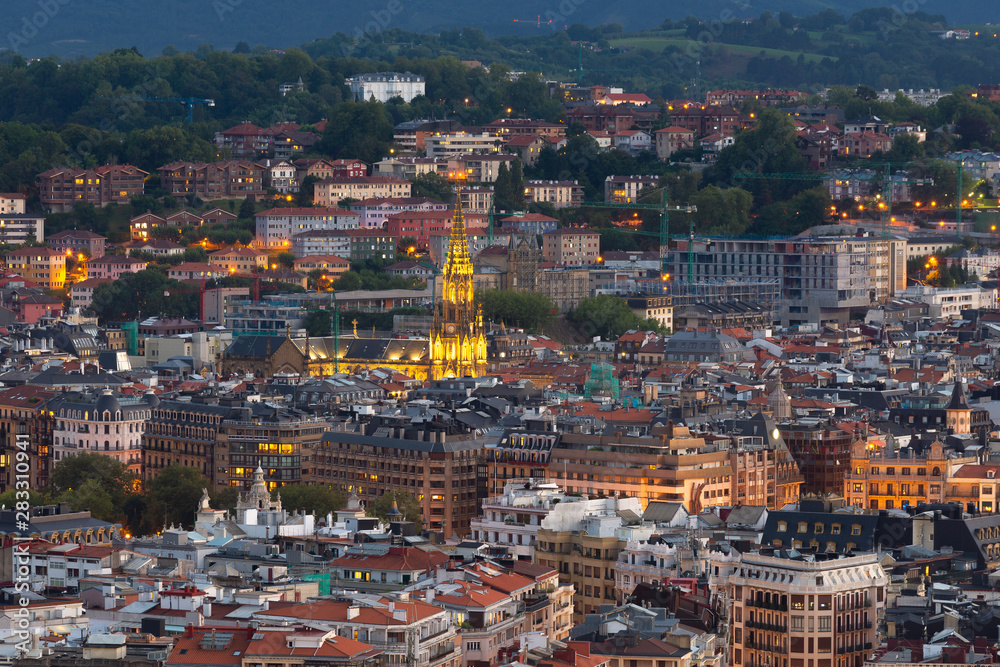 Donostia-San Sebastian with the cathedral of the Good Shepherd at twilight from Ulia mountain, Basque Country, Spain