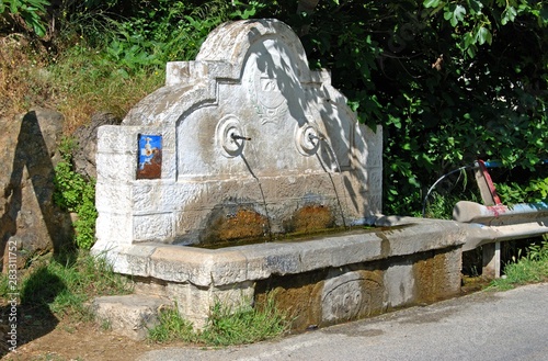 Stone drinking fountain near Chorro gorge, Andalusia, Spain.