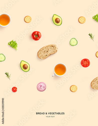 Fototapeta Naklejka Na Ścianę i Meble -  Creative layout made of avocado, tomato, cucumber, onion, bread and tea on beige background. Flat lay. Food concept. Macro  concept.
