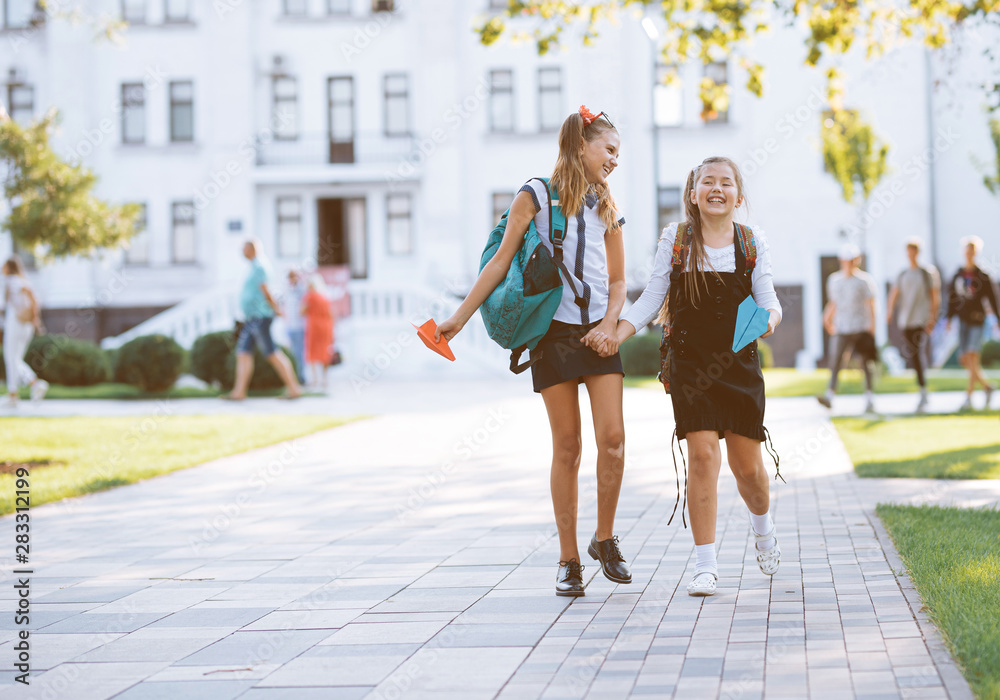girls schoolgirls girlfriends walk walks near school in the park