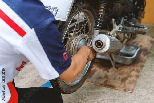 motorcycle engine repair with soft-focus and over light in the background photo