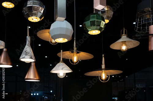 Many hanging lamps displayed in a showroom