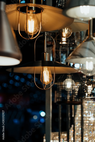 Many hanging lamps displayed in a showroom