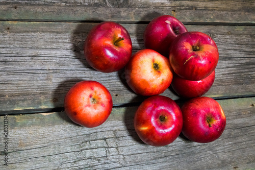 Red apples on gray wooden background.