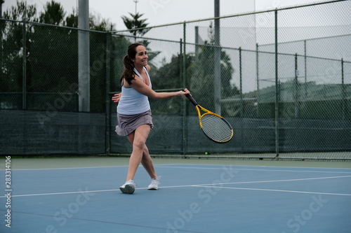 Young woman playing tennis © Haley