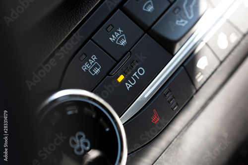 Auto button switch on a modern car. Button for air condition and rear window heating.