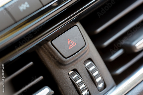 Hazard light switch on a modern car. Safety technology. Close up shot.
