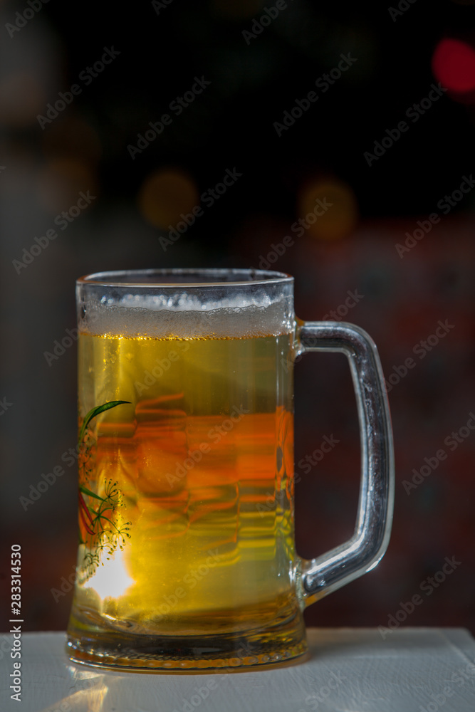 Glass of beer on a background of illumination Glass of beer on a background of illumination