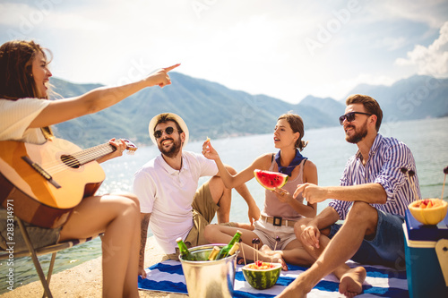 Young people having fun on summer vacation.Happy friends drinking tropical cocktails on the beach.