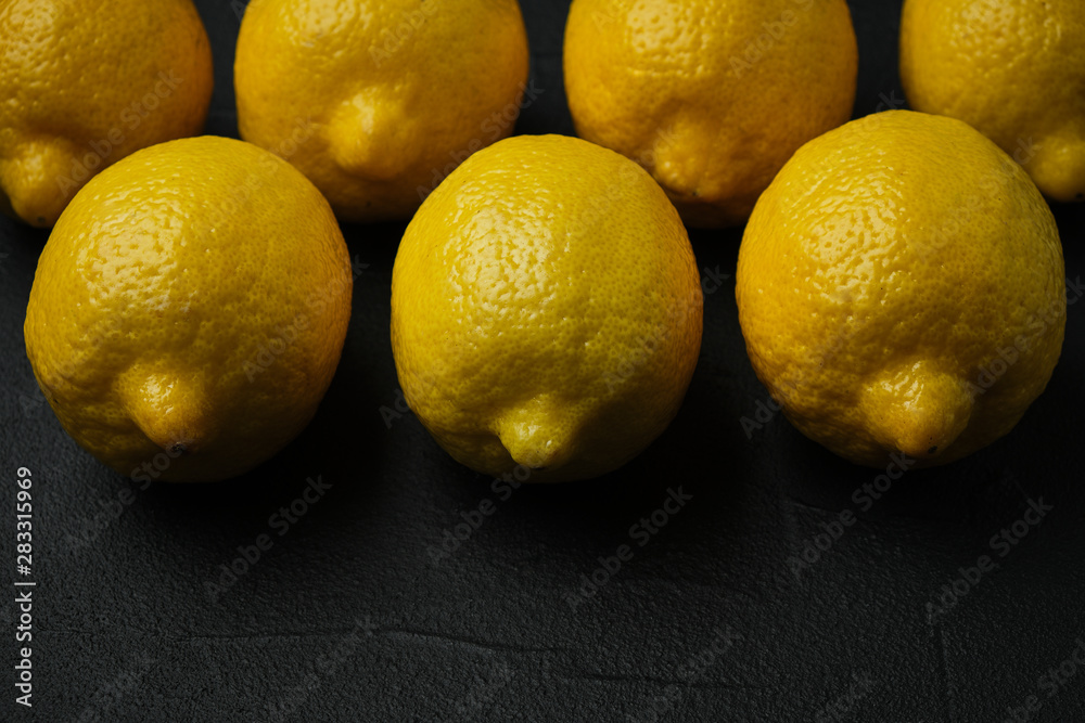 fresh whole lemons on dark background with space for text. top view fresh whole lemons on dark background with space for text. top view