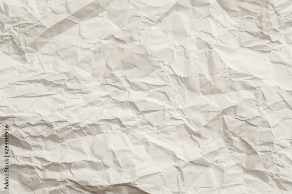 Ivory crumpled paper sheet. Crushed texture design. Abstract art background. Copy space.