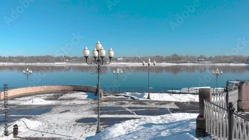 Snowy city in winter and river pier