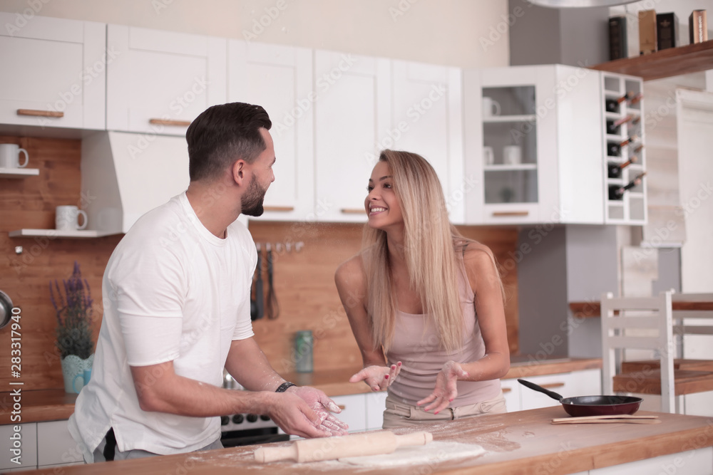 young couple communicates in the home kitchen young couple communicates in the home kitchen