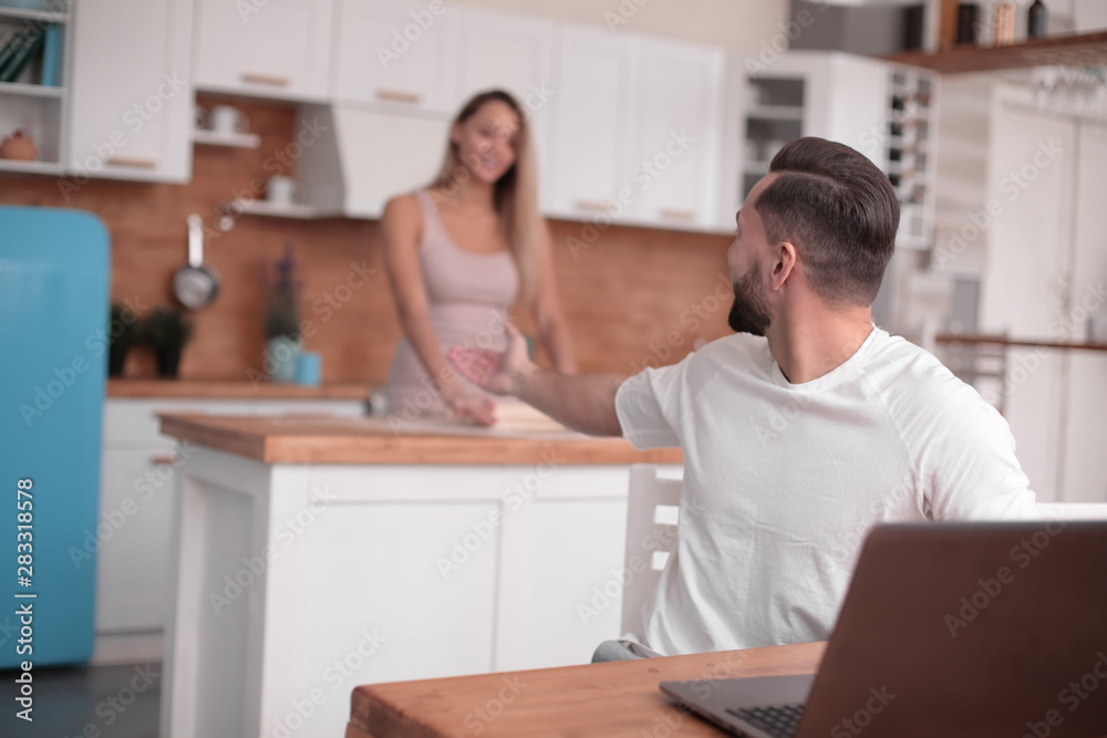 young married couple communicates in their kitchen young married couple communicates in their kitchen