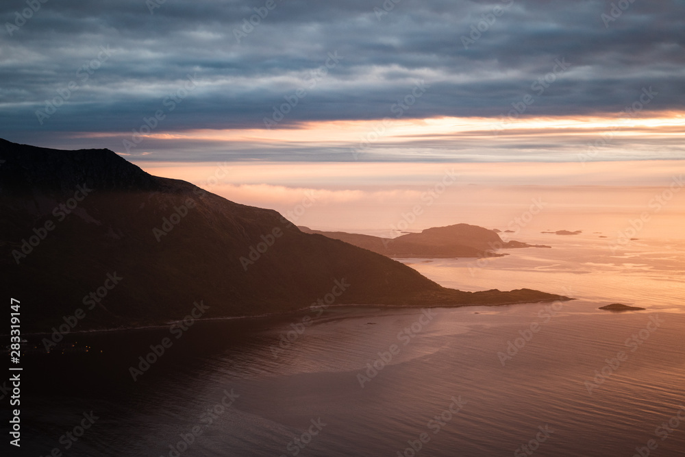 Fjord landscape in Norway with mountains and sea in the golden hour