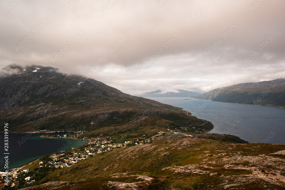 Fjord landscape in Norway with mountains and sea and a town