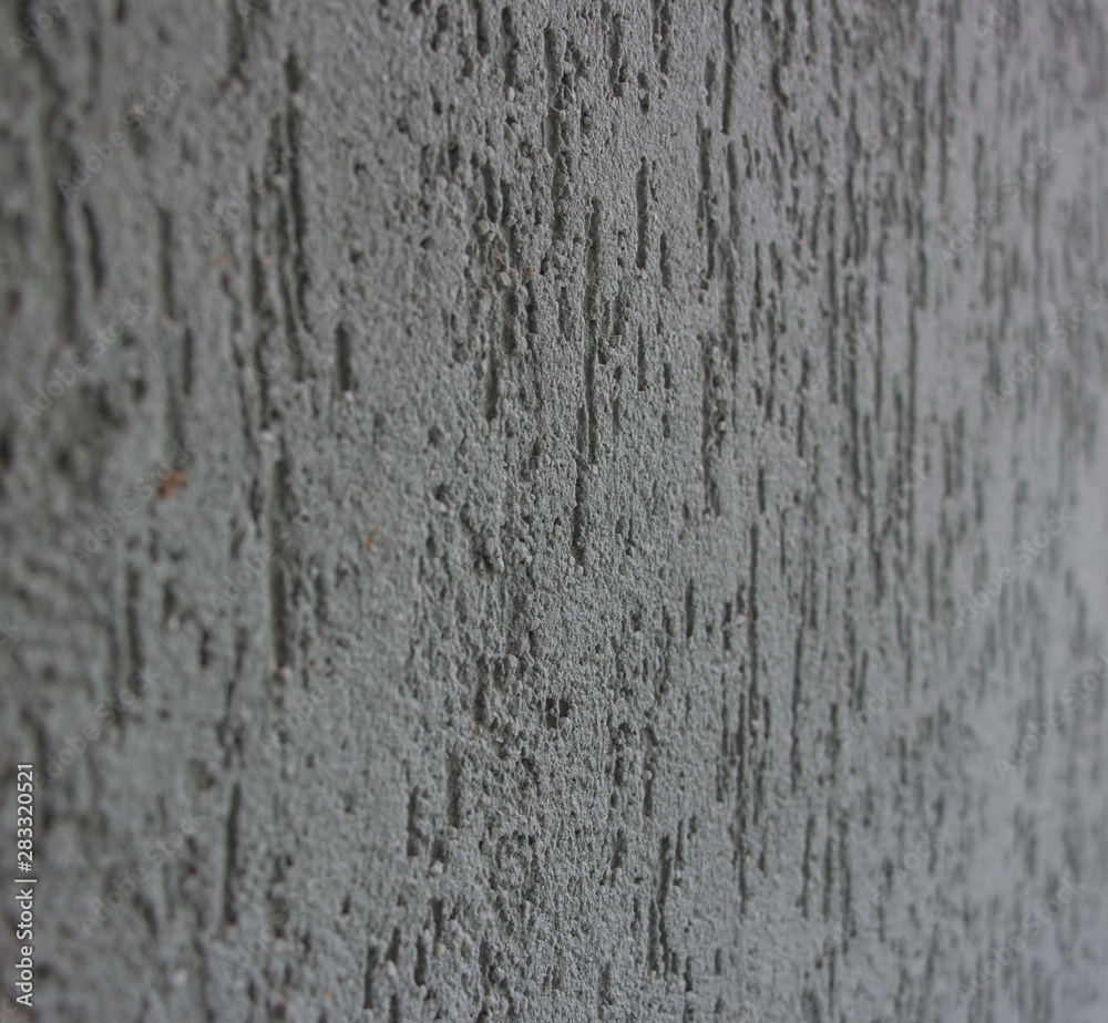 Green wall, stucco. Rough embossed surface. Background, texture. Close-up.