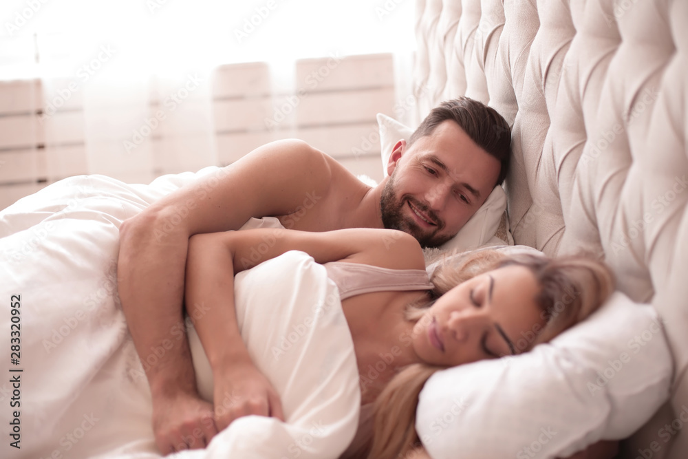 loving man looking at his sleeping girlfriend loving man looking at his sleeping girlfriend