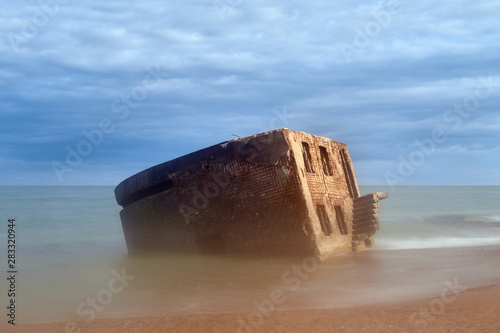 Fototapeta Naklejka Na Ścianę i Meble -  Bunker ruins near the Baltic Sea beach, part of the old fortress in the former Soviet Union base 