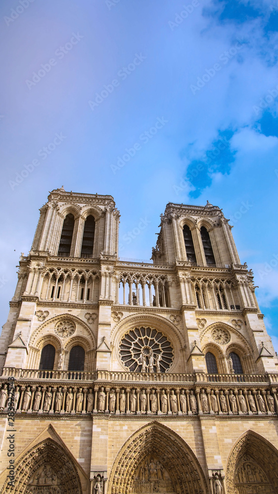 Vertical of Basilica of the Sacre Couer on Montmartre with blue sky and clouds , Paris, France. Catholic church cathedral is popular in Europe