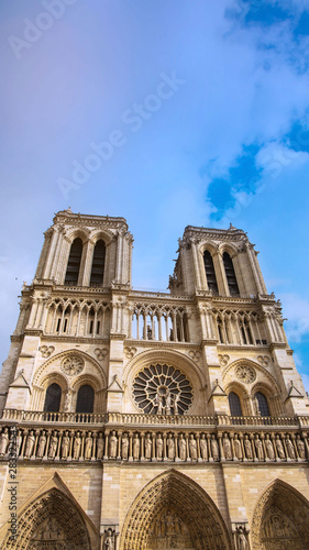 Vertical of Basilica of the Sacre Couer on Montmartre with blue sky and clouds , Paris, France. Catholic church cathedral is popular in Europe