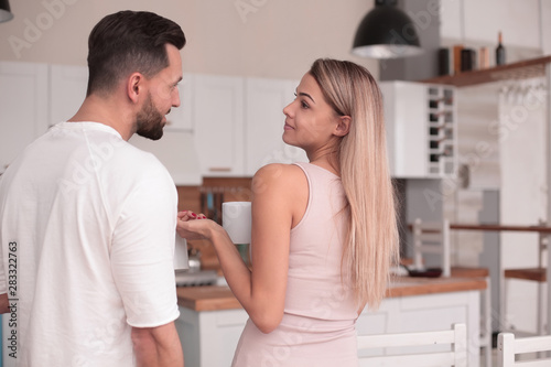 dreams of a young couple standing in their kitchen