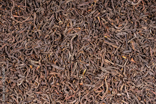 Black tea leaves background. Abstract food textures. Close up