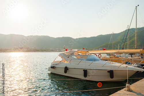 MARMARIS. TURKEY - JULY 30: yacht and boats moored on a pier near the city and mountains - Marmaris on July 30, 2019 in Turkey
