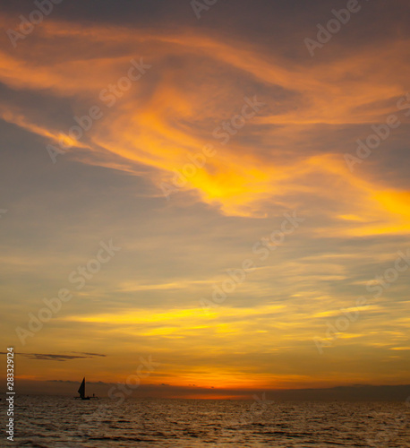 sunset over sea. small ship against the background of an orange sunset sky. sun that drowns in the ocean. sunset on the pacific ocean  © Дмитрий Панасенко