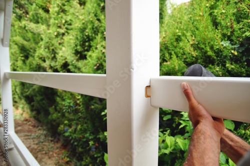 carpentry joints. Wood post, rabbet joint. Mounting the carport. carpenter using a hammer to connect a spruce wooden beam for Carport outdoor construction. Woodworking and carpentry concept. 