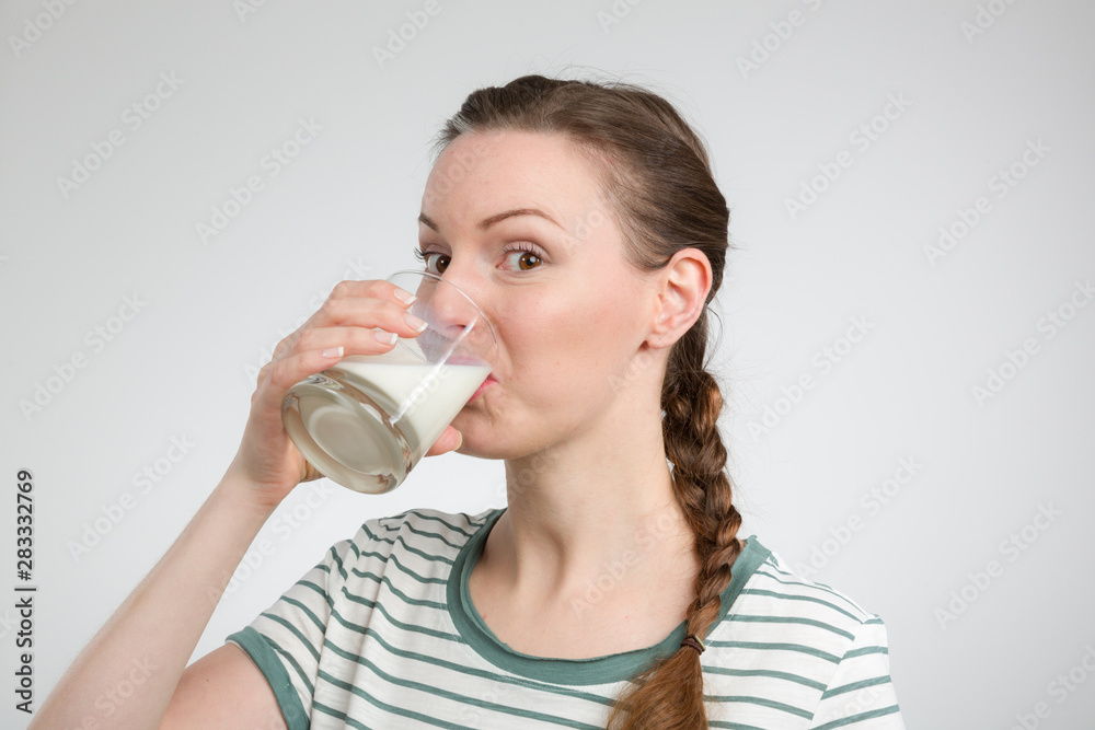 young woman drinking a glass of fresh milk young woman drinking a glass of fresh milk