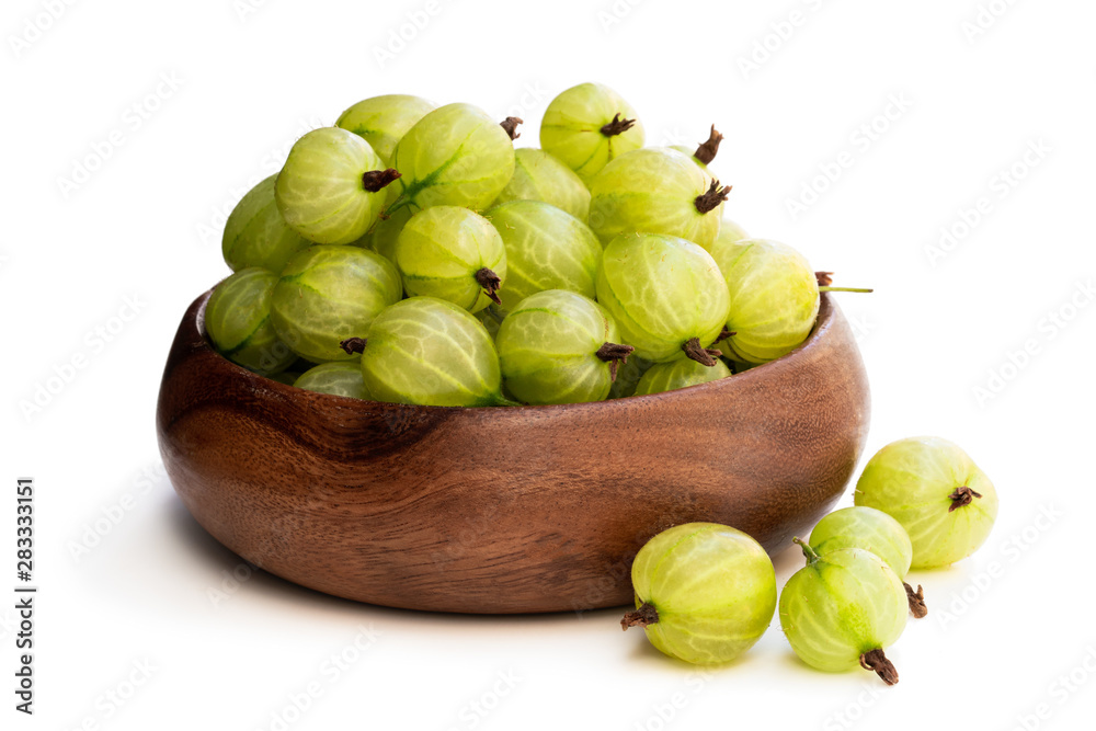 Gooseberries in wooden table isolated on white Gooseberries in wooden table isolated on white