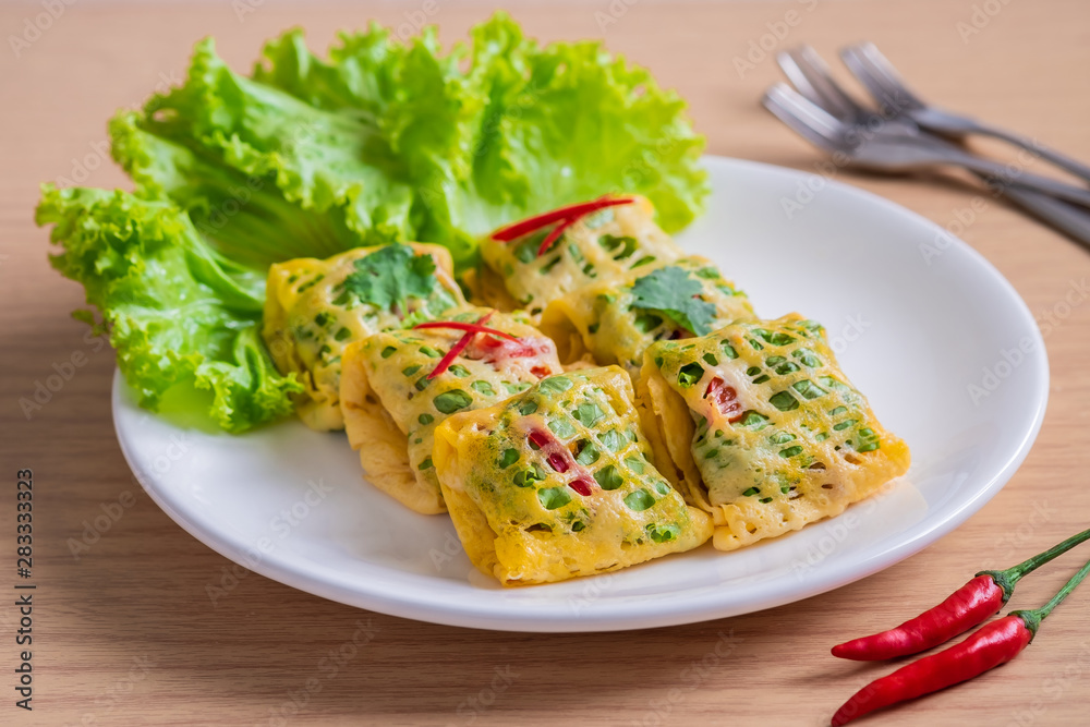 Fried minced pork, prawns, vegetable and nut wrapped in egg net (Latieng), Thai traditional food Fried minced pork, prawns, vegetable and nut wrapped in egg net (Latieng), Thai traditional food