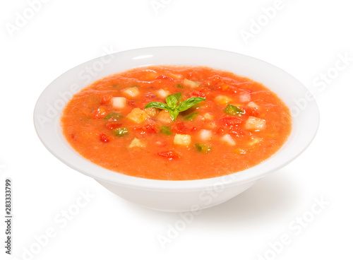 Traditional spanish cold gazpacho soup in a bowl on a white background photo