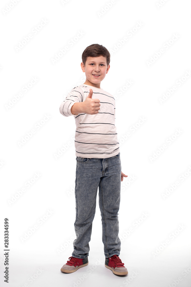 Full-length portrait of a smiling teenager boy civing you an approving gesture, isolated Full-length portrait of a smiling teenager boy civing you an approving gesture, isolated