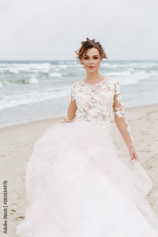Portrait of a beautiful bride on the beach in windy weather Portrait of a beautiful bride on the beach in windy weather