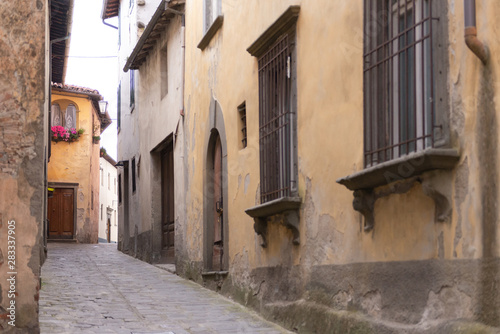 Fototapeta Naklejka Na Ścianę i Meble -  The Town Of Barga. Italy. Summer 2019. Narrow street rising up. Street in the Central part of the historic center.