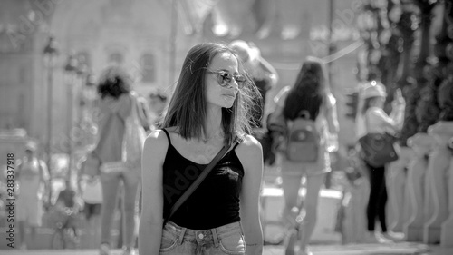 Young attractive woman walks over Alexandre III Bridge in Paris