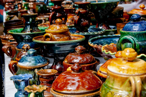 Colourful ceramics pots and dishes on the market, photo as background