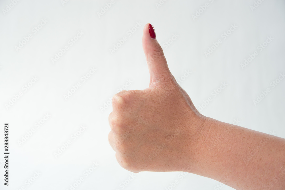 close-up of woman's hand with red nails pointing index finger on white background