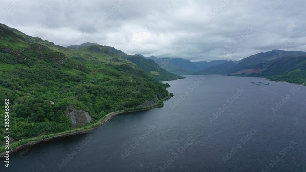Aerial view of picturesque landscape of Highlands of Scotland around Eilean Donan Castle, lush green hills and sea Loch Duich - panorama of Scotland from above, United Kingdom, Great Britain, Europe Aerial view of picturesque landscape of Highlands of Scotland around Eilean Donan Castle, lush green hills and sea Loch Duich - panorama of Scotland from above, United Kingdom, Great Britain, Europe