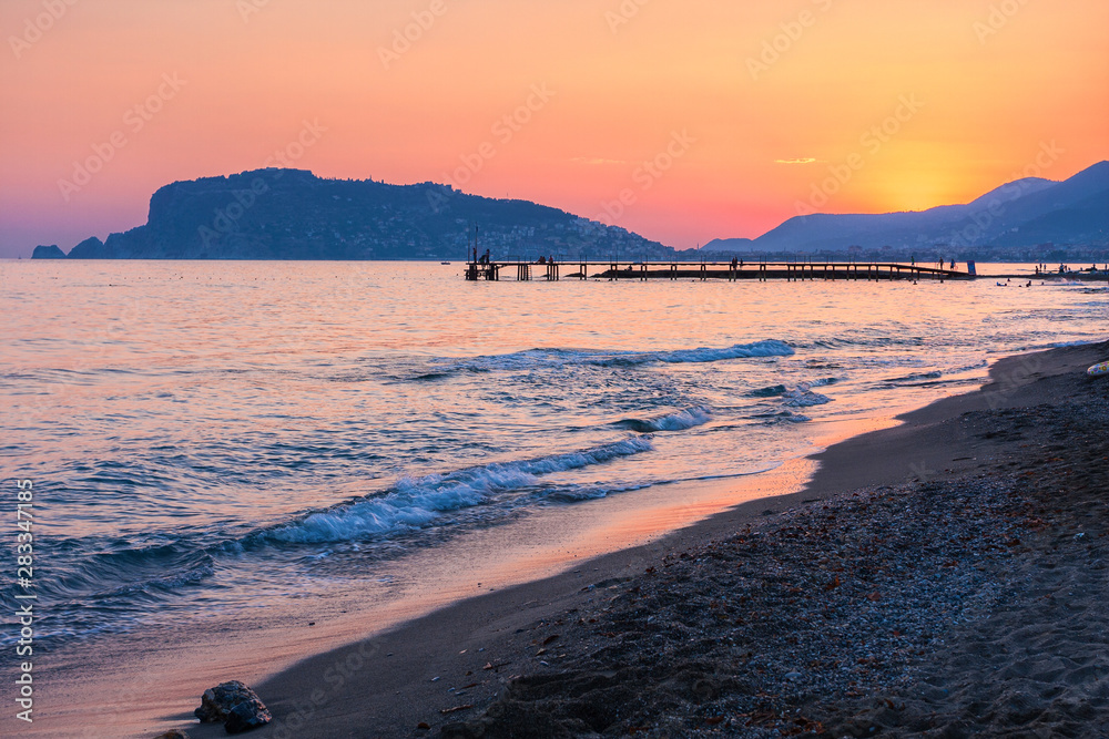 Scenic view from  Alanya beach at  the sunset, Turkey.  At the background  Alanya Peninsula.