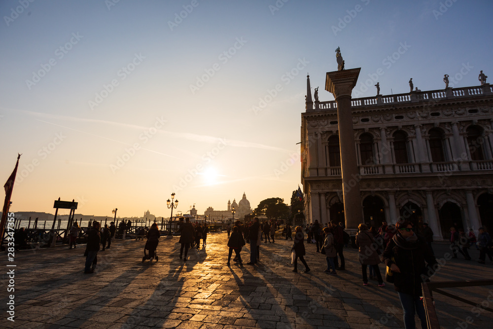 Obraz premium Traditional gondola and The Grand Canal and the Basilica di Santa Maria della Salute in Venice at sunset