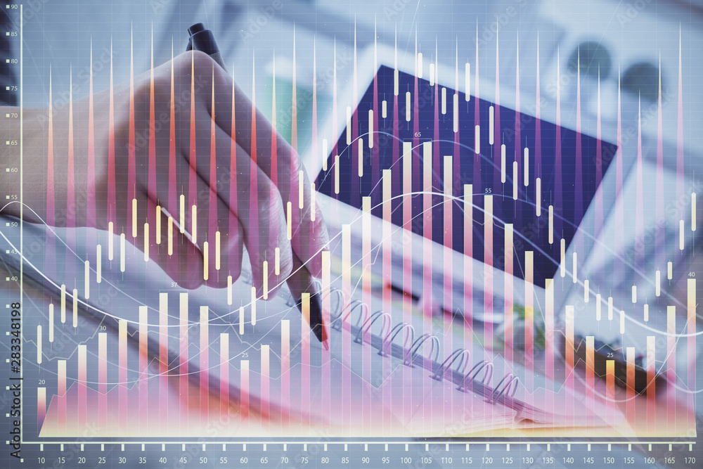 Financial forex graph drawn over hands taking notes background. Concept of research. Multi exposure Financial forex graph drawn over hands taking notes background. Concept of research. Multi exposure