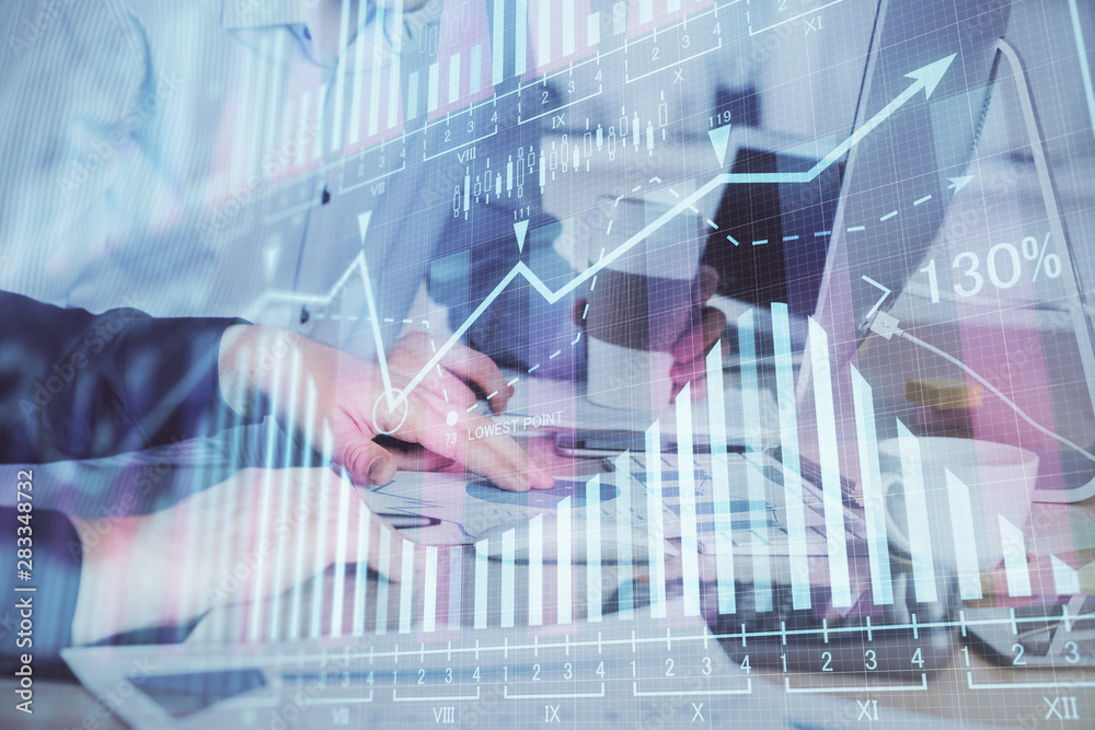 Multi exposure of chart with man typing on computer in office on background. Concept of hard work. Multi exposure of chart with man typing on computer in office on background. Concept of hard work.