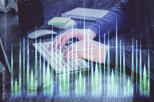 Wallpaper Mural Stock graph with businessman typing on computer in office on background. Concept of analysis. Double exposure. Torontodigital.ca